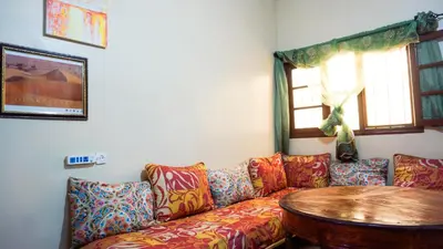 a living room with a couch and a table at Ouarzazate Youth Hostel YHO in Ouarzazate