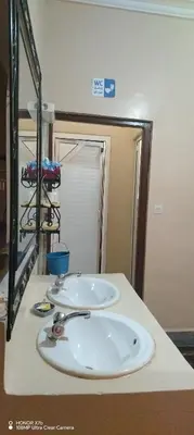 a bathroom counter with a sink and a mirror at Ouarzazate Youth Hostel YHO in Ouarzazate