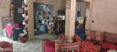 a living room with couches and pillows in a room at Ouarzazate Youth Hostel YHO in Ouarzazate