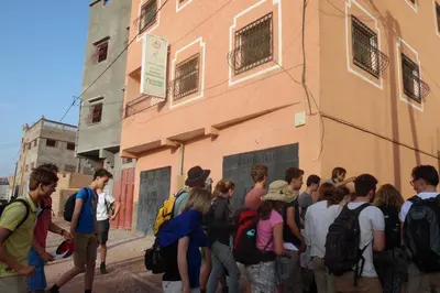 a group of people standing outside of a building at Ouarzazate Youth Hostel YHO in Ouarzazate