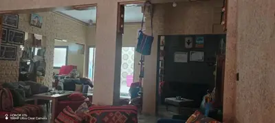 a living room with couches and chairs and a window at Ouarzazate Youth Hostel YHO in Ouarzazate