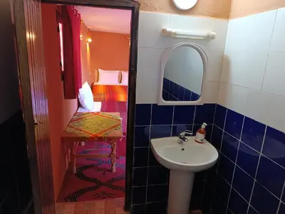 a small bathroom with a sink and a mirror at Bivouac Lot Of Stars in Ouarzazate