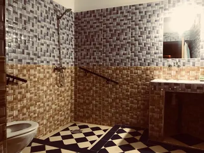 a bathroom with a toilet and a sink and a mirror at Bivouac Lot Of Stars in Ouarzazate