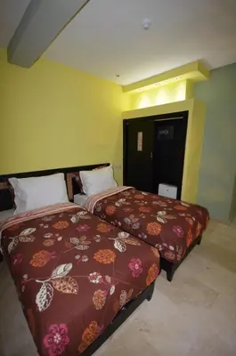 a hotel room with two beds in a room at Hôtel-Café-Restaurant Pyramides, in Taza