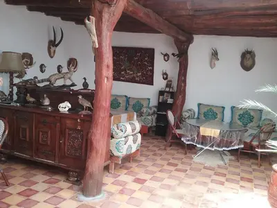 a living room filled with furniture and a table at Relais De Tahla in Ain Boumahdi