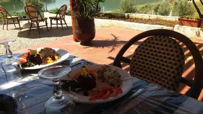 a table with two plates of food on it at Relais De Tahla in Ain Boumahdi