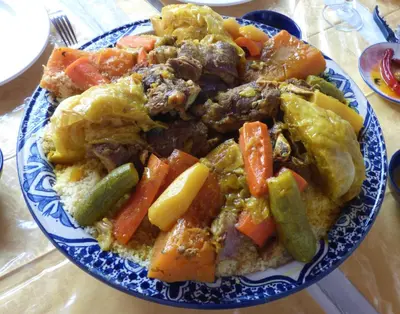 a plate of food with vegetables on a table at Relais De Tahla in Ain Boumahdi