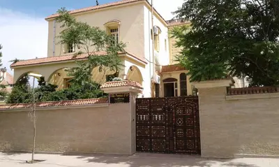 a large house with a gate in front of it at Villa Pomme d'Or in Midelt