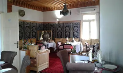 a restaurant with tables and chairs in a room at Villa Pomme d'Or in Midelt