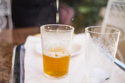 a glass of beer is sitting on a table at Villa Pomme d'Or in Midelt