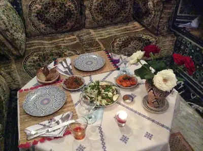 a table with plates of food and flowers on it at Fès Riad Scalia Traditional Guesthouse Morocco in Fès