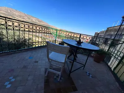 a table and a chair on a balcony at Fès Riad Scalia Traditional Guesthouse Morocco in Fès