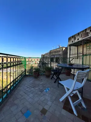 a patio with a table and chairs and a fence at Fès Riad Scalia Traditional Guesthouse Morocco in Fès