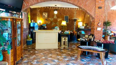 a room with an entry way with a counter and tables at Aurocher Marrakech Ourika Oukaimeden in Oukkainrdem