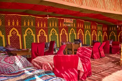 a room with red chairs and a colorful wall at Auberge Restaurant Telouet in Telouet