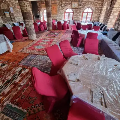a large room with pink chairs and tables in it at Auberge Restaurant Telouet in Telouet