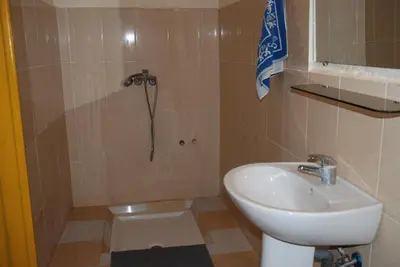 a bathroom with a sink and a shower at d'hôte Jnane-Dar Diafa in Tamegroute