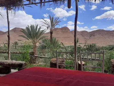 a red table with a view of the desert at Luna del fuego in Ifri