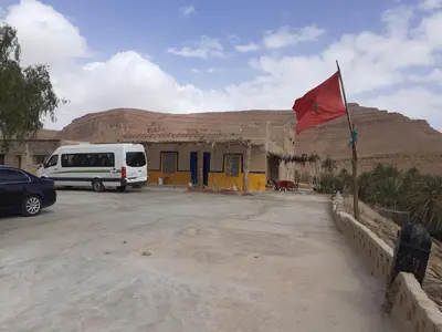 a van parked in front of a building with a red flag at Luna del fuego in Ifri