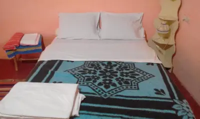 a bedroom with a bed with a moroccan bedspread at Luna del fuego in Ifri