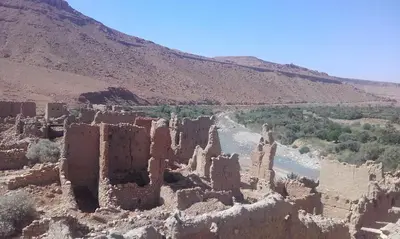 an old castle on the side of a river at Luna del fuego in Ifri