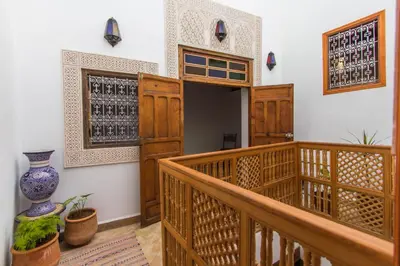 a room with a staircase and a sign on the wall at Dar Bhija in Fès