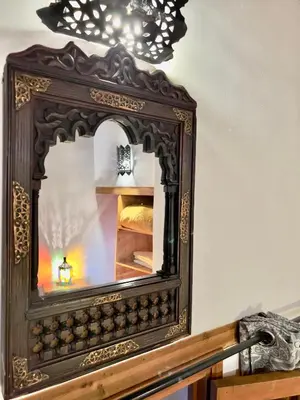 a mirror on top of a wooden table at Dar Bhija in Fès