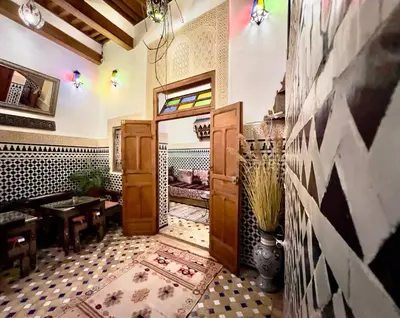 a room with a door and a table in a room at Dar Bhija in Fès