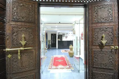 an open door to a room with a red rug at Rose Valley Hotel in Ouarzazate