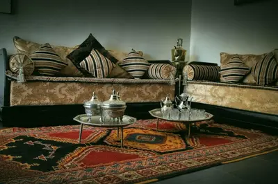 a living room with a couch and two tables at Rose Valley Hotel in Ouarzazate