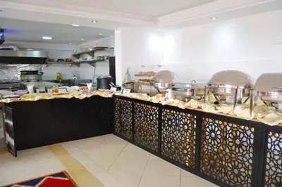 a kitchen with a counter with food on it at Rose Valley Hotel in Ouarzazate