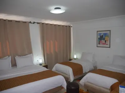 a hotel room with two beds in a room at Rose Valley Hotel in Ouarzazate