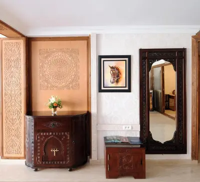 a room with a mirror and a dresser and a table at Aparthotel Les Oliviers Suites & Spa in Fès