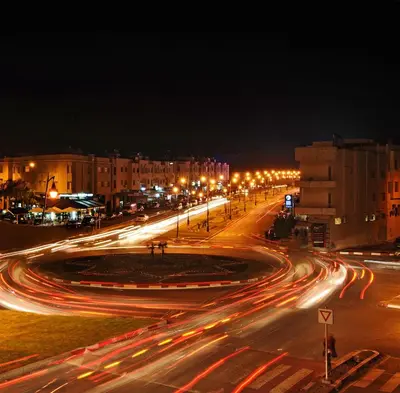 a busy city street at night with street lights at Aparthotel Les Oliviers Suites & Spa in Fès