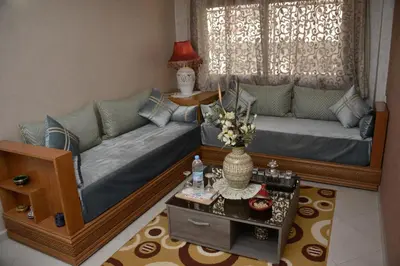 a living room with a couch and a table at Aparthotel Les Oliviers Suites & Spa in Fès