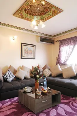 a living room with a couch and a coffee table at Aparthotel Les Oliviers Suites & Spa in Fès