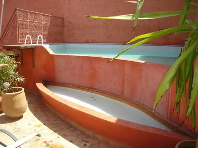 a bath tub in a room with at Riad El Ma in Meknès