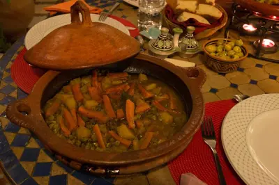 a pot of stew with carrots and vegetables on a table at Riad El Ma in Meknès