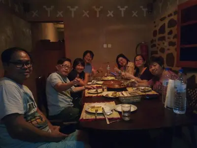 a group of people sitting around a table eating at Dar Zara in Ouarzazate
