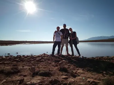 a group of people standing on the shore of a lake at Dar Zara in Ouarzazate