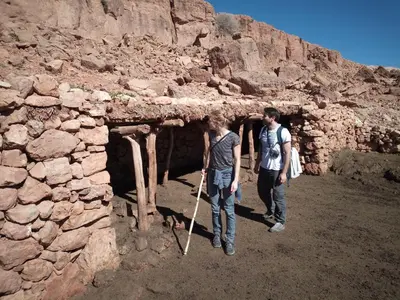 two people standing in front of a stone building at Dar Zara in Ouarzazate