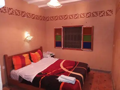 a bedroom with a bed and a window at Dar Zara in Ouarzazate