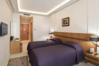 a hotel room with two beds in a room at Hôtel l'escale in Fès