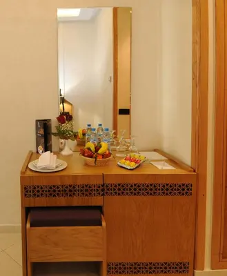 a table with a bowl of fruit and a mirror at Hôtel l'escale in Fès