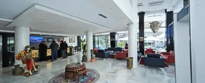 a lobby of a building with people standing in it at Hôtel l'escale in Fès