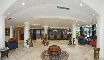 a lobby with couches and a table in a building at Hôtel l'escale in Fès