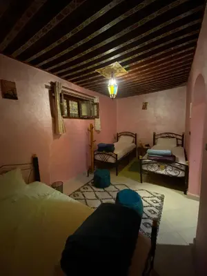 a bedroom with two beds in a room with a ceiling at la Kasbah salam in Fès