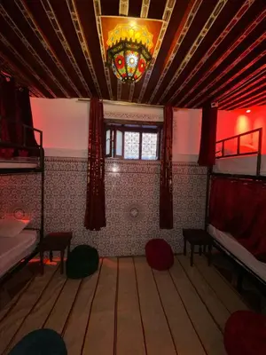 a room with two bunk beds and a chandelier at la Kasbah salam in Fès