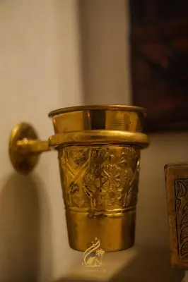 a gold cup is sitting on a table at Luxury Camp Chebbi in Merzouga