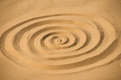a spiral in the sand on a beach at Bivouac Les Nomades & Foum zguid camel trekking and tours in Foum Zguid